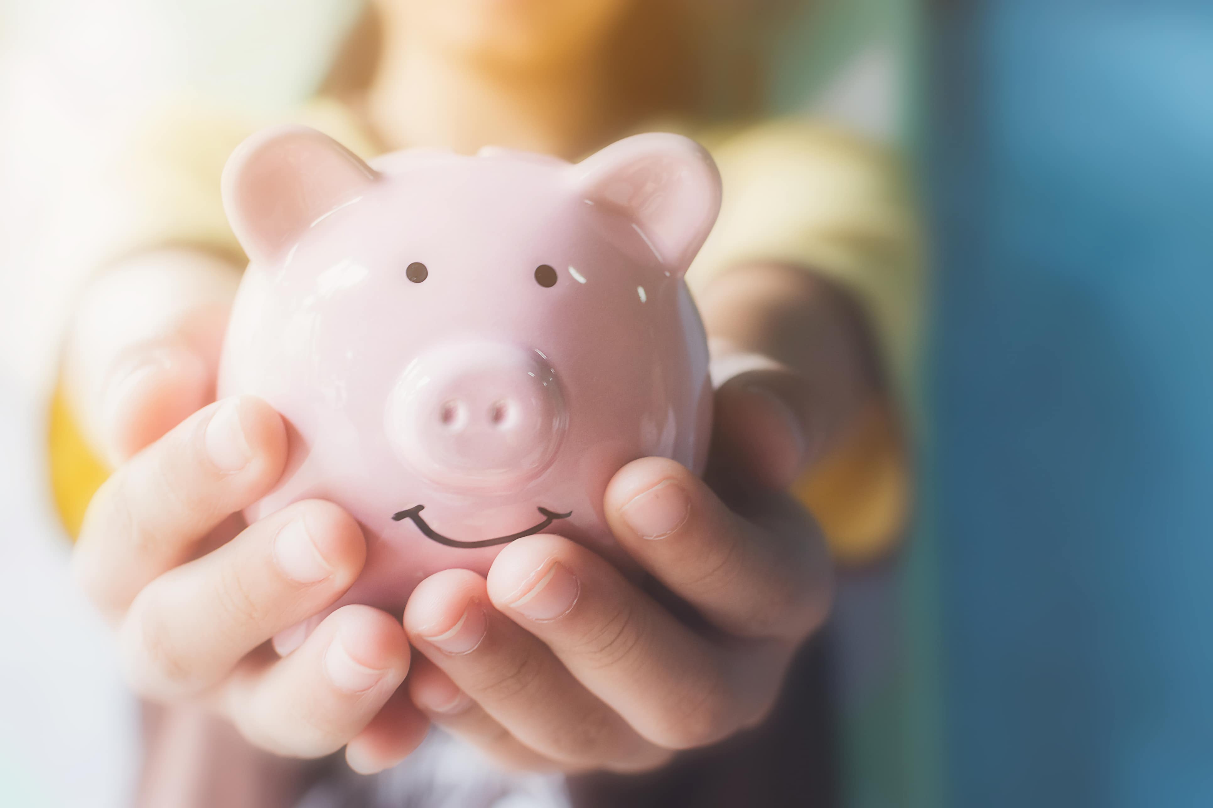 Woman holding a piggy bank symbolizing the positive aspect of chapter 7 bankruptcy.
